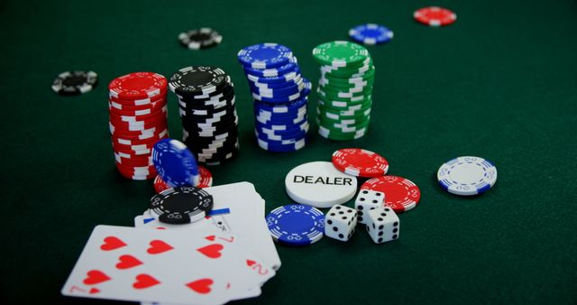 Playing card, dices and casino chips on poker table in casino