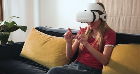 Teen Girl Exploring Virtual Reality World at Home