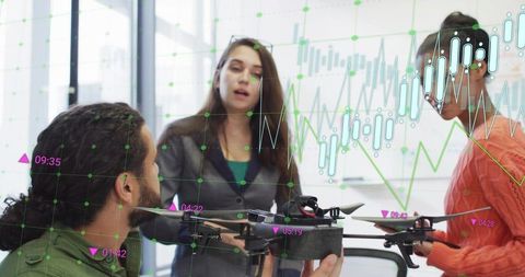 Team collaborating on drone prototype with data analytics overlay, brainstorming in office
