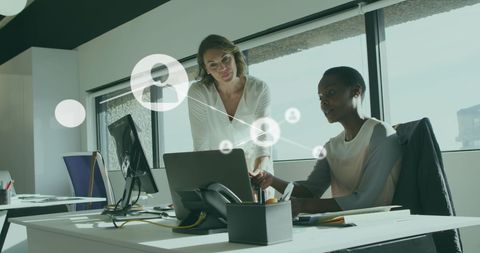 Diverse Team Analyzing Digital Reports in Modern Office