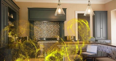 Modern kitchen featuring mosaic backsplash, pendant lights, banquette nook and yellow wisps