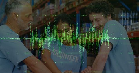 Diverse Warehouse Workers Collaborating with Financial Graphs Overlay