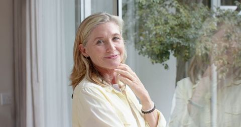 Elegant Mature Woman Gazing Reflectively in Natural Light