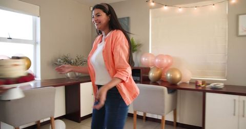 Woman Enjoys Festive Indoor Celebration with Balloons
