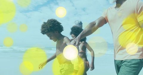 Happy Family Strolling on Beach with Bright Light Flares