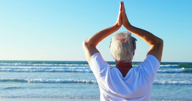 Senior man doing yoga on beach at sunrise - Download Free Stock Images Pikwizard.com