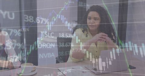 Confident woman analyzing financial charts in modern office