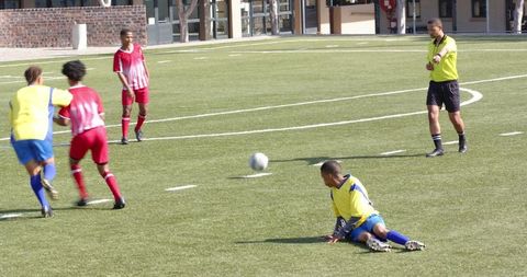 Youth Soccer Match with Players in Colorful Uniforms on School Field