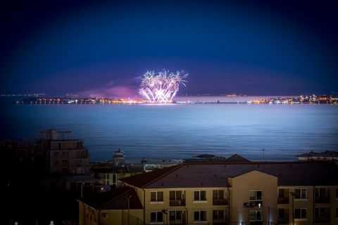 Spectacular Fireworks Display Over Tranquil Harbor at Night