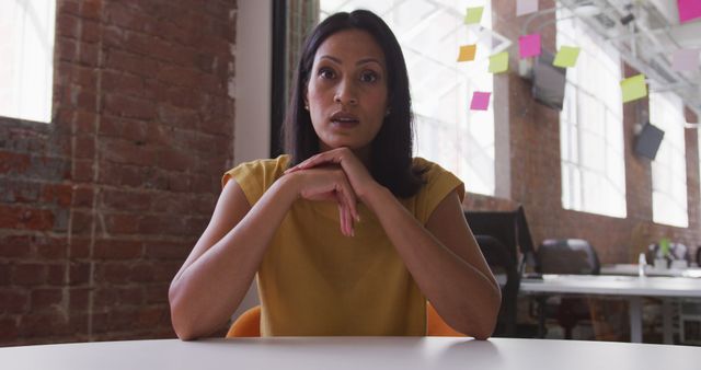 Businesswoman in Co-Working Space Looking Thoughtful - Download Free Stock Images Pikwizard.com