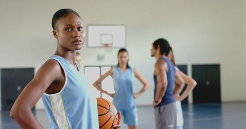 Young Female Basketball Players Preparing for Game in Gym Court