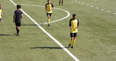 Football Players Practicing on Grass Field in Sportswear