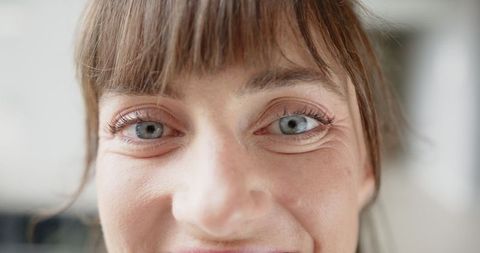 Close-up Portrait of Happy Woman Smiling with Blue Eyes