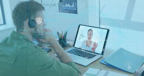 Man at Workspace Using Laptop and Headset with Digital Security Icons