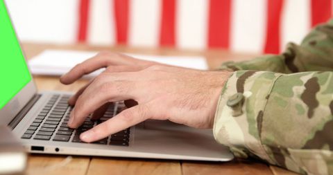 Caucasian Male Soldier Working on Laptop with Green Screen