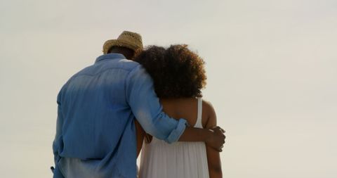 Romantic african american couple embracing at beachfront