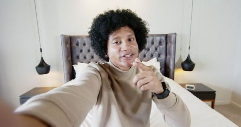 Young Man Vlogging from Bedroom with a Relaxed Vibe