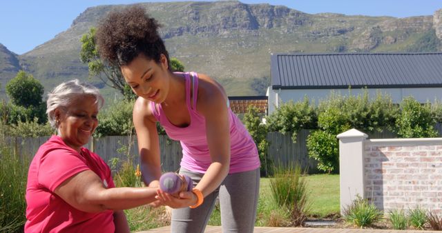 Caregiver Assisting Senior Woman with Arm Exercises in Garden - Download Free Stock Images Pikwizard.com