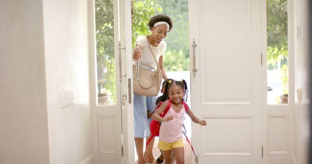 Happy african american mother, daughter and son entering house with joy - Download Free Stock Photos Pikwizard.com