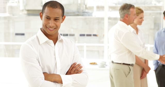 Confident Businessman in Office with Colleagues Networking - Download Free Stock Images Pikwizard.com