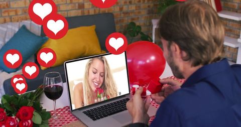 Caucasian couple in virtual date with heart icon overlay