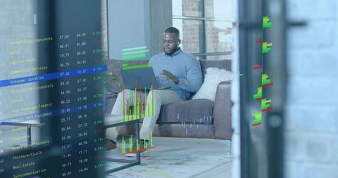 Businessman Analyzing Financial Data on Laptop in Office