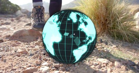 Futuristic hologram globe hovering on rugged trail