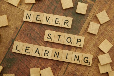 Inspiring words 'never stop learning' in scrabble tiles