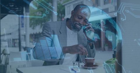 Businessman Communicating at Cafe Amidst Digital Technology Overlay