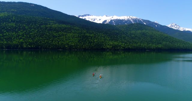 Scenic Lake with Kayakers and Snow-Capped Mountains - Download Free Stock Images Pikwizard.com