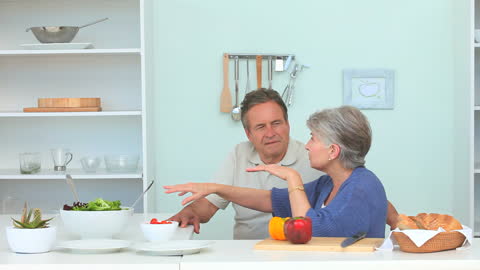 Senior Couple Enjoying Meal Preparation in Modern Kitchen