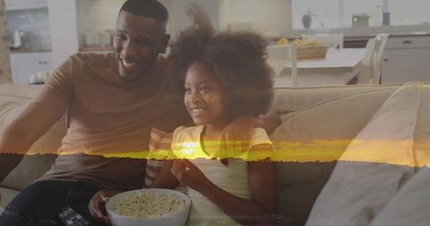 Father and Daughter Enjoying Movie Time at Home