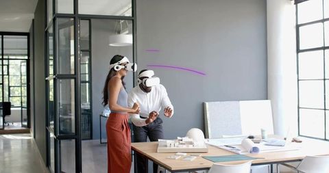 Coworkers Using VR Headsets for Innovative Office Planning