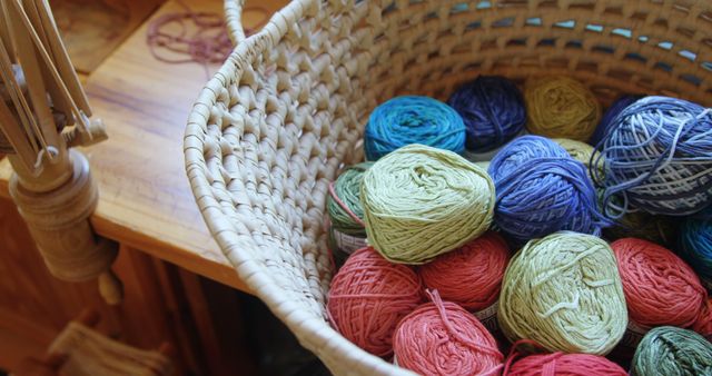 Bunches of different coloured woollen yarn kept in basket in workshop 4k 
