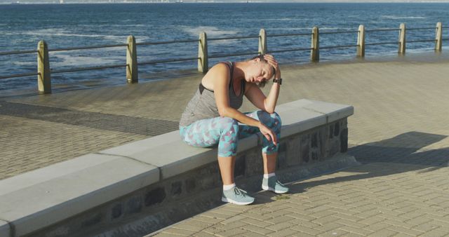 Woman Taking Rest During Morning Run Along Seaside - Download Free Stock Images Pikwizard.com