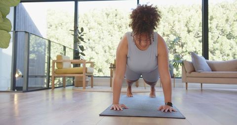 Woman Practicing Plank in Serene Living Room Setting