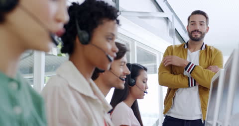 Manager Overseeing Diverse Team in Modern Call Center