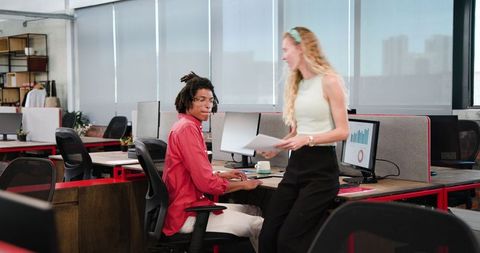 Colleagues Discussing Project Details in Modern Office