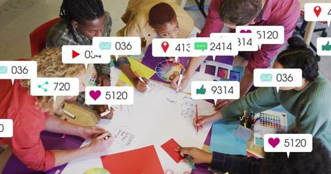 Design team collaborating on social campaign with color palettes and live notifications