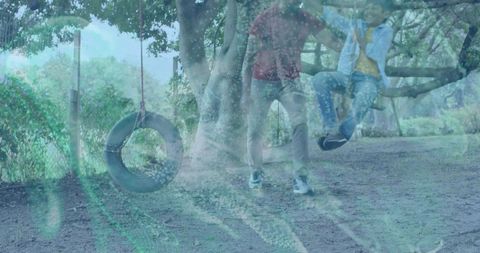 Guardian Watching Child Playing on Low Tree Branch with Tire Swing in Park