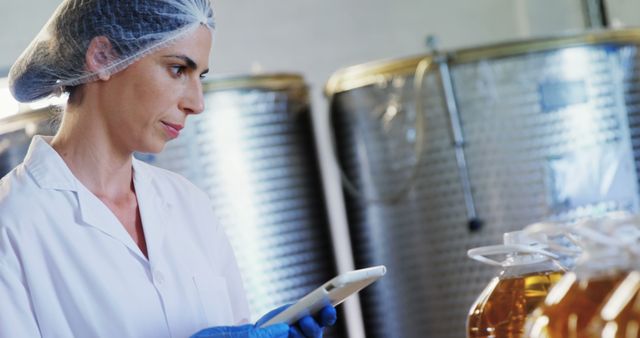 Female Food Scientist Working with Digital Tablet in Industrial Setting - Download Free Stock Images Pikwizard.com