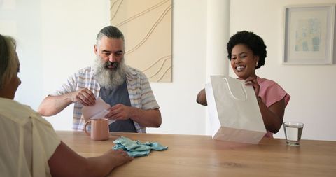 Senior Couple Enjoying Surprise Gift Exchange at Home