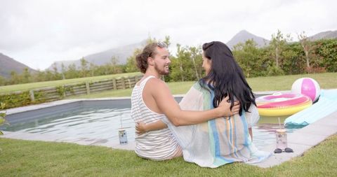 Couple Relaxing by Luxury Poolside Retreat