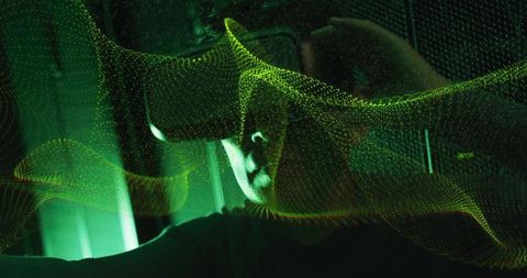 Asian man wearing vr headset experiencing holographic projections