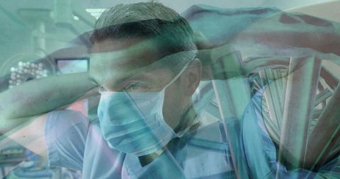 Surgeon adjusting mask in operating room with intense focus