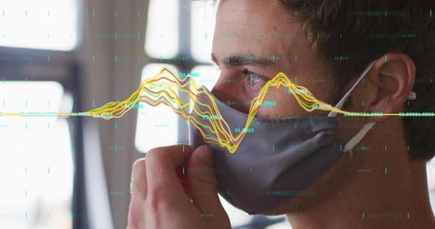 Man in Office Adjusting Mask with Technology Overlay