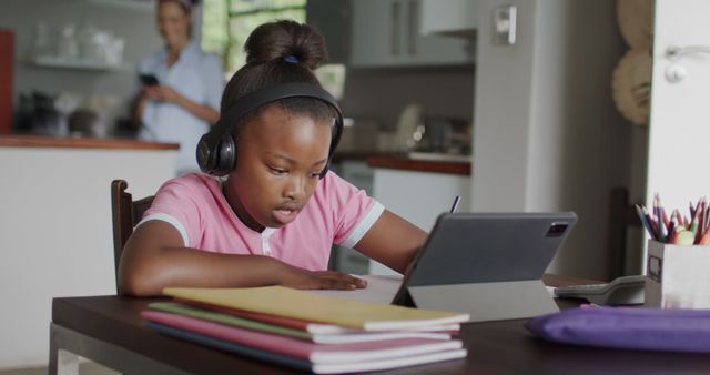 African american girl learning online using tablet at home. Lifestyle, childhood, communication, online education and domestic life, unaltered.