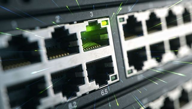 Illuminated rj45 ethernet port macro on network switch with green led and gold contacts