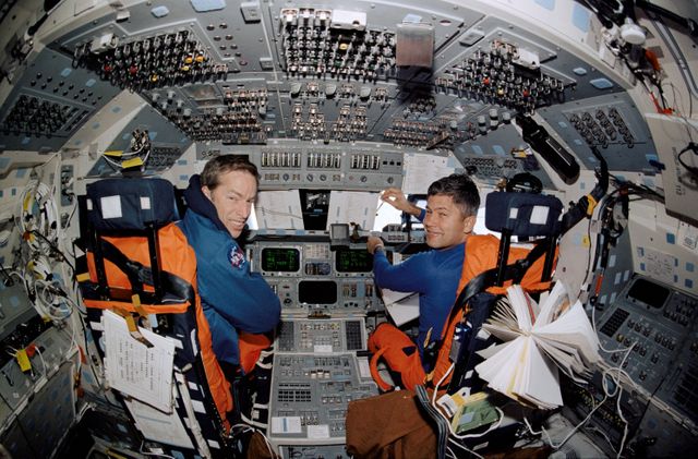 STS113-369-024 (6 December 2002) --- A &#0147;fish-eye&#0148; lens on a 35mm camera records astronauts James D. Wetherbee (left) and Paul S. Lockhart, STS-113 mission commander and pilot, respectively, on the forward flight deck of the Space Shuttle Endeavour.