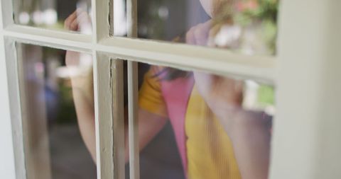 Girl with Backpack Looking Out Window Reflects Safety and Isolation